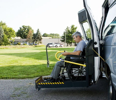 man on a wheelchair inside van